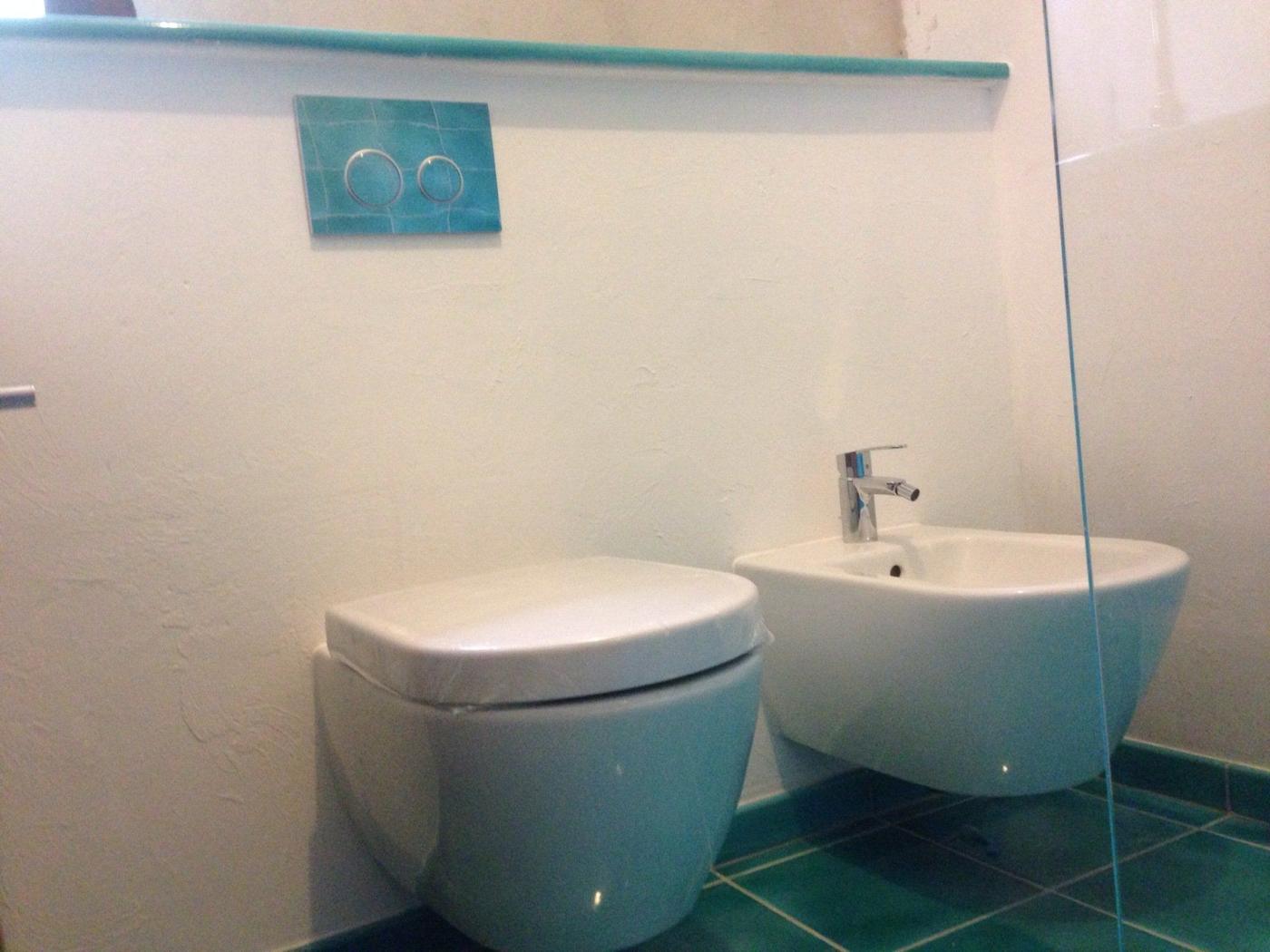 WC et bidet suspendus avec plaque de commande encastrée assortie à la faïence